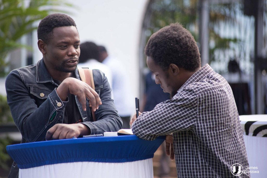 The writer having a chat with local film director Joseph Ken Ssebaggala aka Zenken at the Amakula International Film Festival